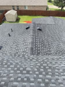 Close-up of a gray roof with ventilation pipes.